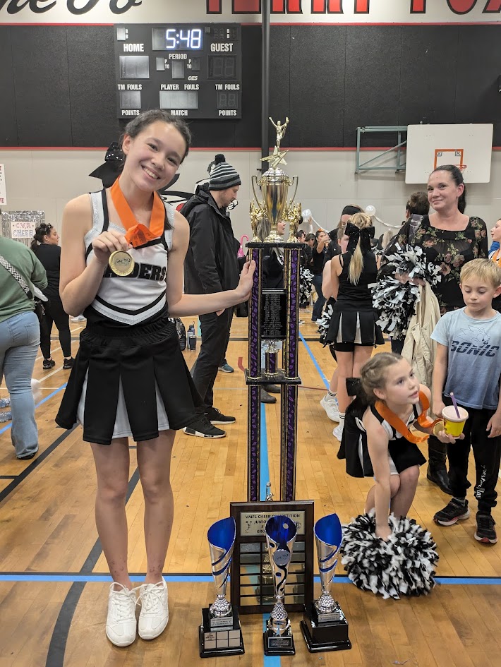 Rae with cheerleading trophy and medal